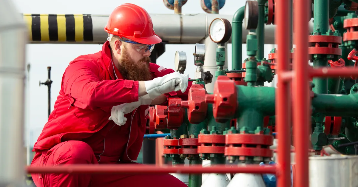 Worker checking valve stem leaks